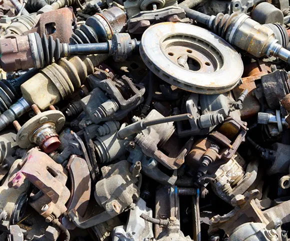 Close-up of assorted engine parts and mechanical components for eco-friendly car recycling.