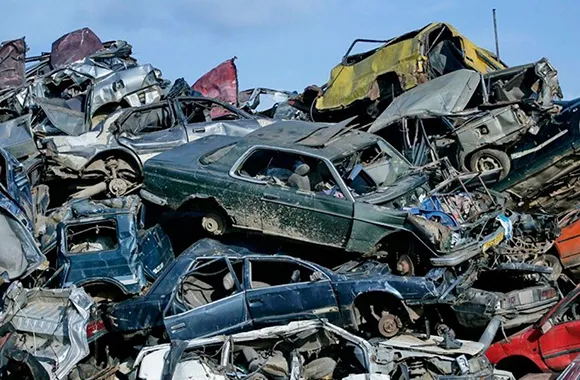 Pile of damaged cars prepared for eco-friendly disposal in Arlington, TX by Junk Car General.