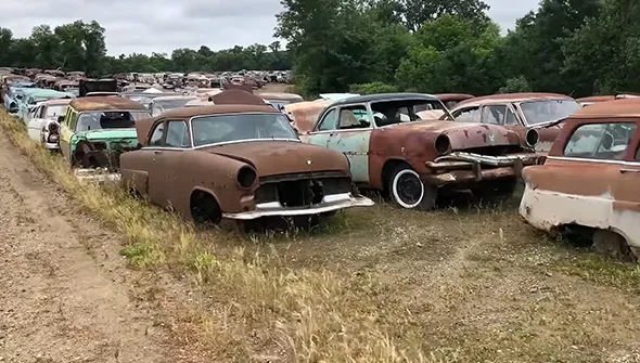 Multiple junk cars lined up for removal in Waxahachie, TX.