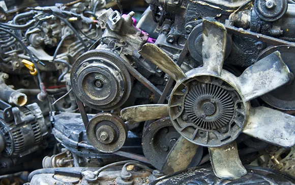 Stack of rusty used car parts for efficient eco-friendly disposal in Plano, TX