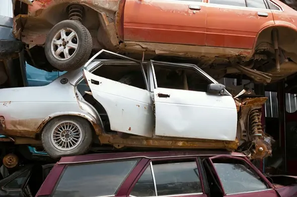 Crushed junk cars stacked in Red Oak TX yard for cash junk car buying service