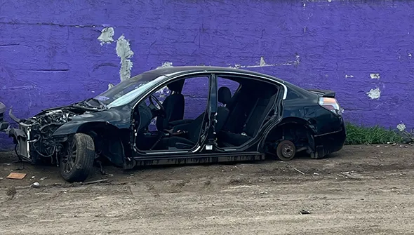 Damaged black car for reliable junk car dealer service in Red Oak, TX