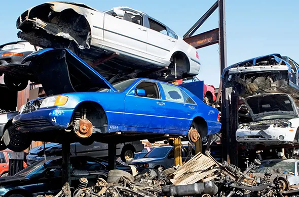 Stack of scrap cars ready for junk car disposal in Plano, TX
