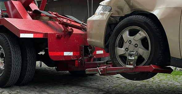 Red tow truck lifting car for same day junk car pickup service in Midlothian TX