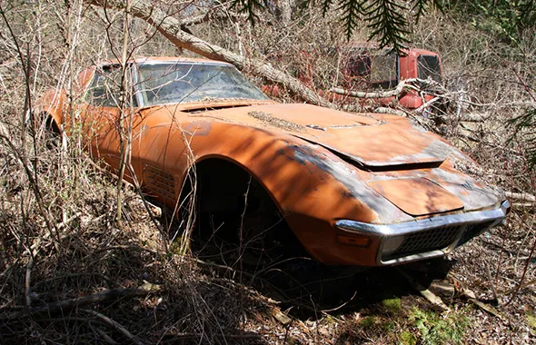Rusty abandoned orange car for no title car buyers service in Irving, TX