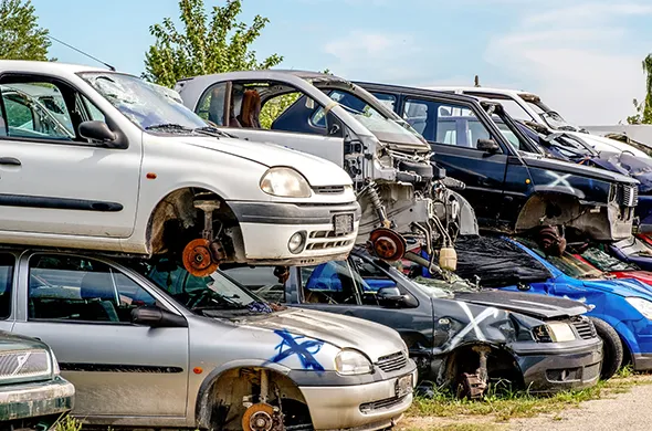 Multiple junk cars lined up for removal in Carleton, TX.